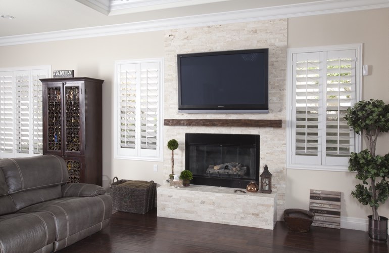 White plantation shutters in a Clearwater living room with solid hardwood floors.
